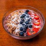 Acai protein smoothie bowl &ndash; high-protein breakfast topped with granola and fresh berries