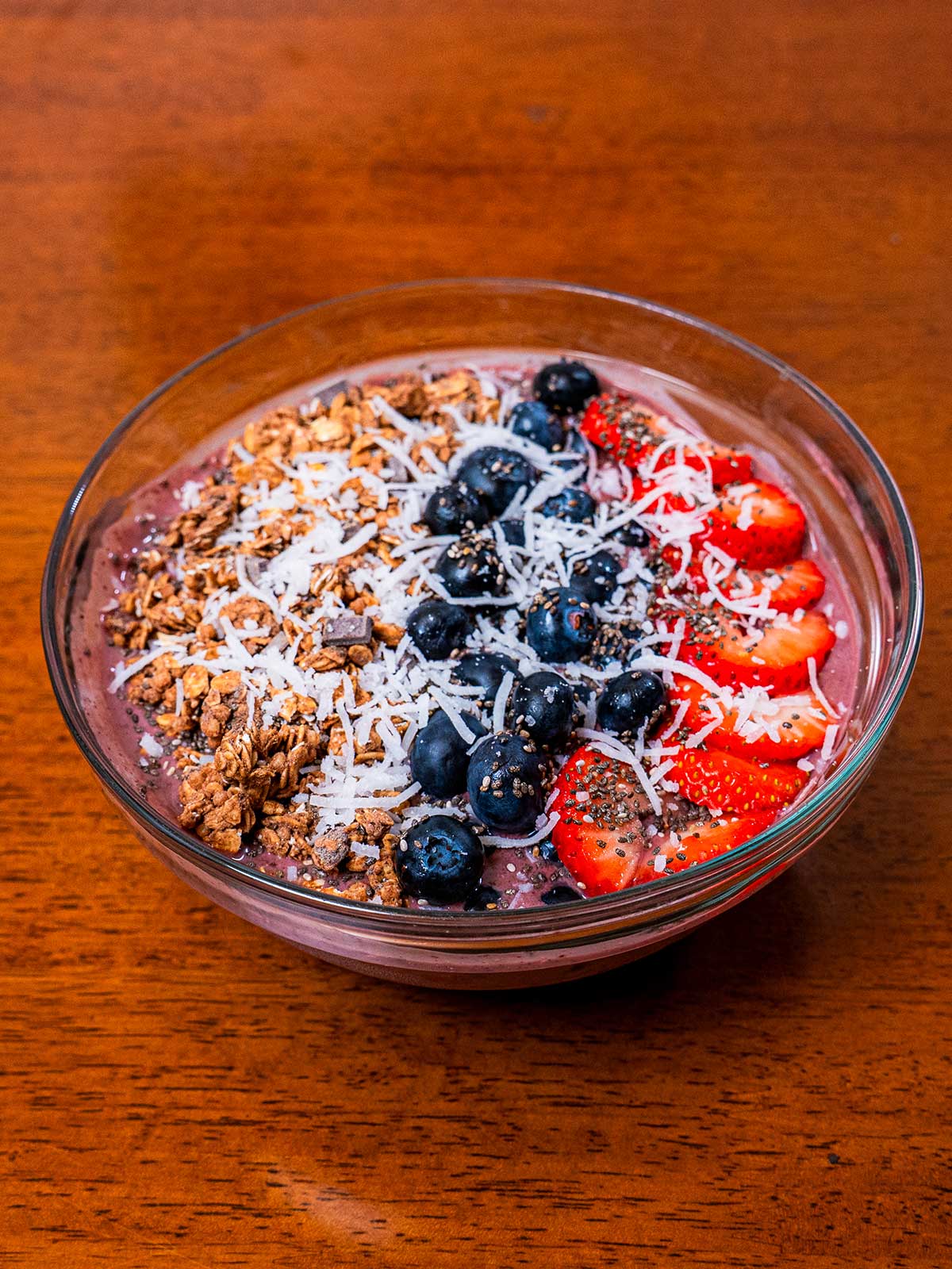 Acai protein smoothie bowl &ndash; high-protein breakfast topped with granola and fresh berries
