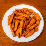 Air fryer sweet potato fries in bowl &ndash; crispy high-protein healthy snack side dish