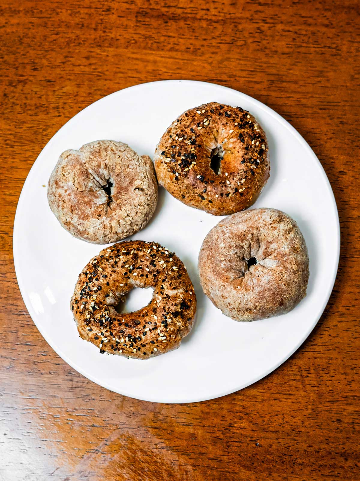 Air fryer whole wheat Greek yogurt bagels hero shot &ndash; fresh high protein bagels on wooden board