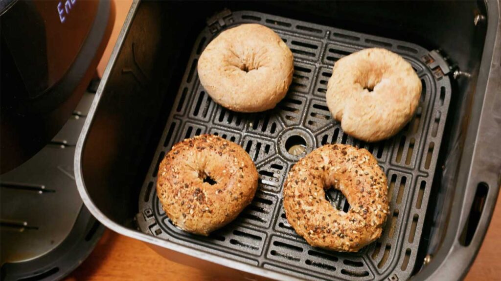 Air fryer whole wheat Greek yogurt bagels close-up &ndash; sliced high protein bagel with cream cheese