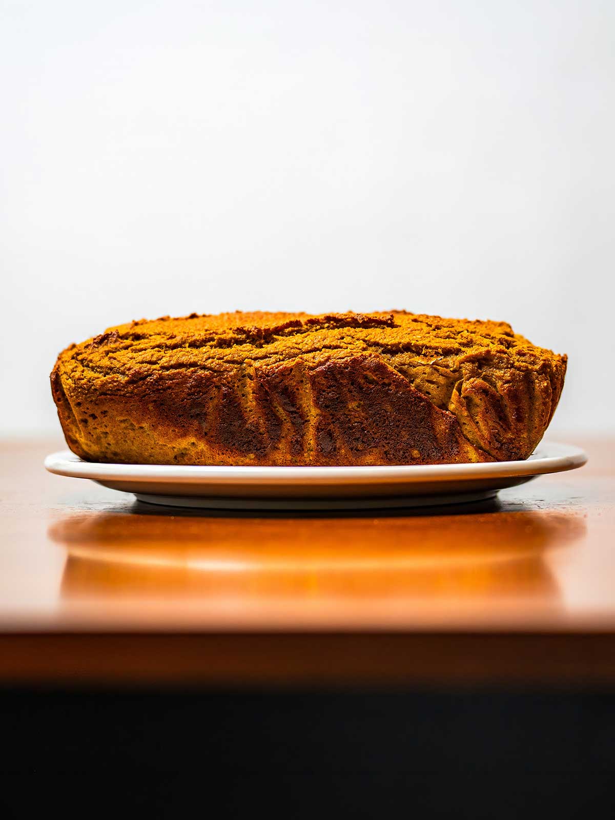 Almond flour protein pumpkin bread hero &ndash; sliced high-protein pumpkin bread on rustic wooden surface