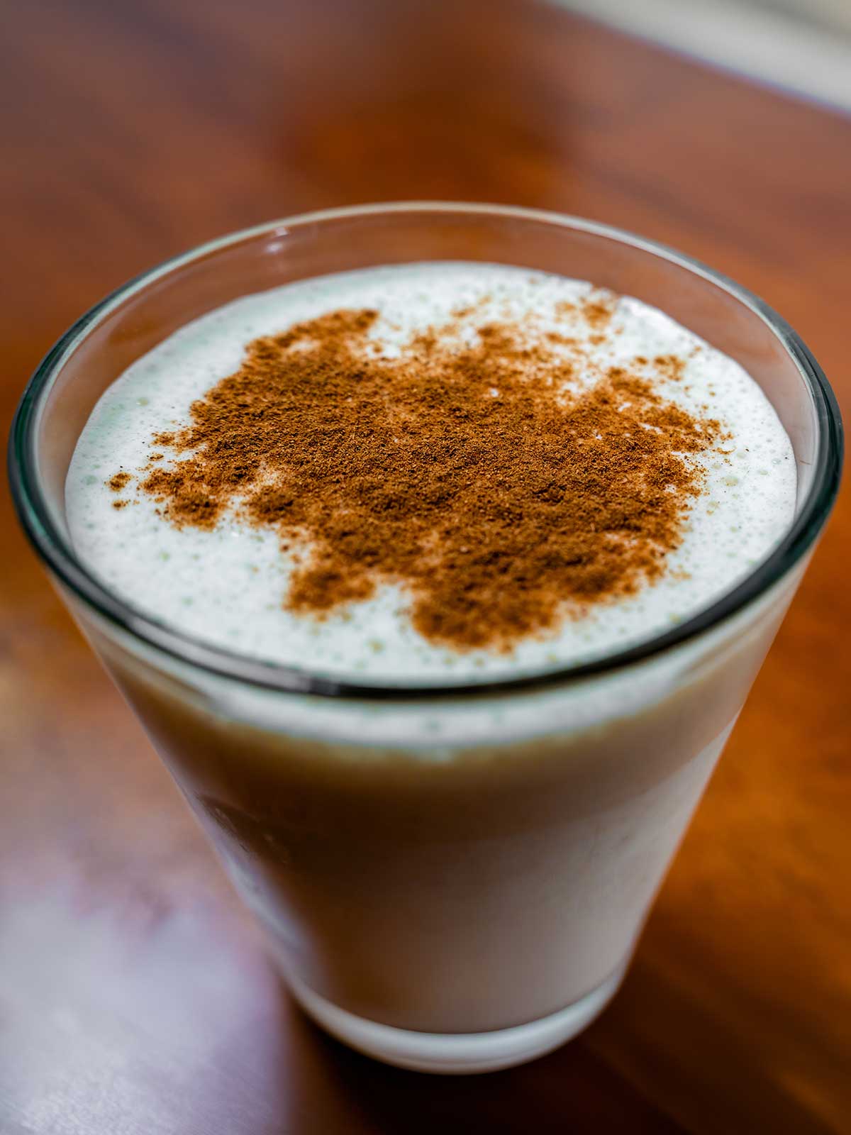 Apple vanilla protein smoothie in a glass &ndash; high-protein breakfast with banana and yogurt
