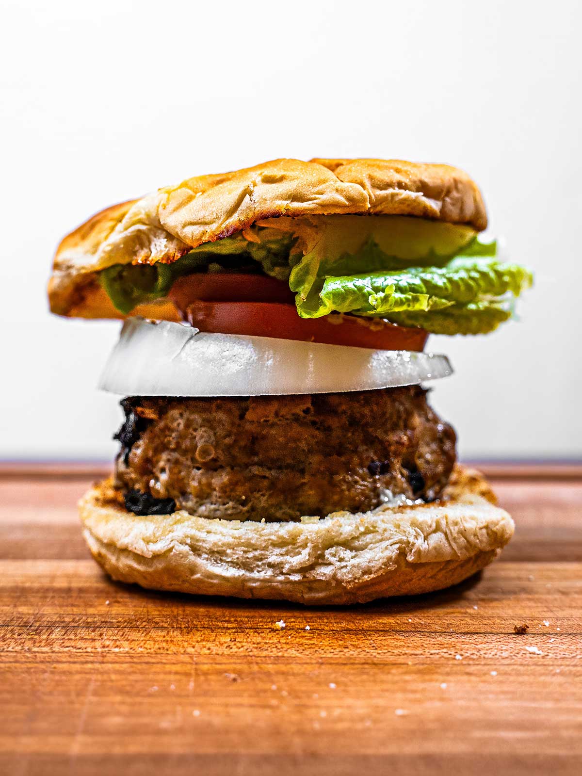 Avocado turkey burger on a plate &ndash; high-protein meal with fresh avocado and toppings