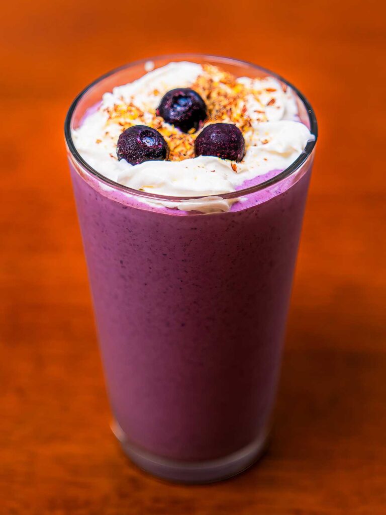 Blueberry cheesecake protein smoothie &ndash; high-protein breakfast in a glass with fresh blueberries