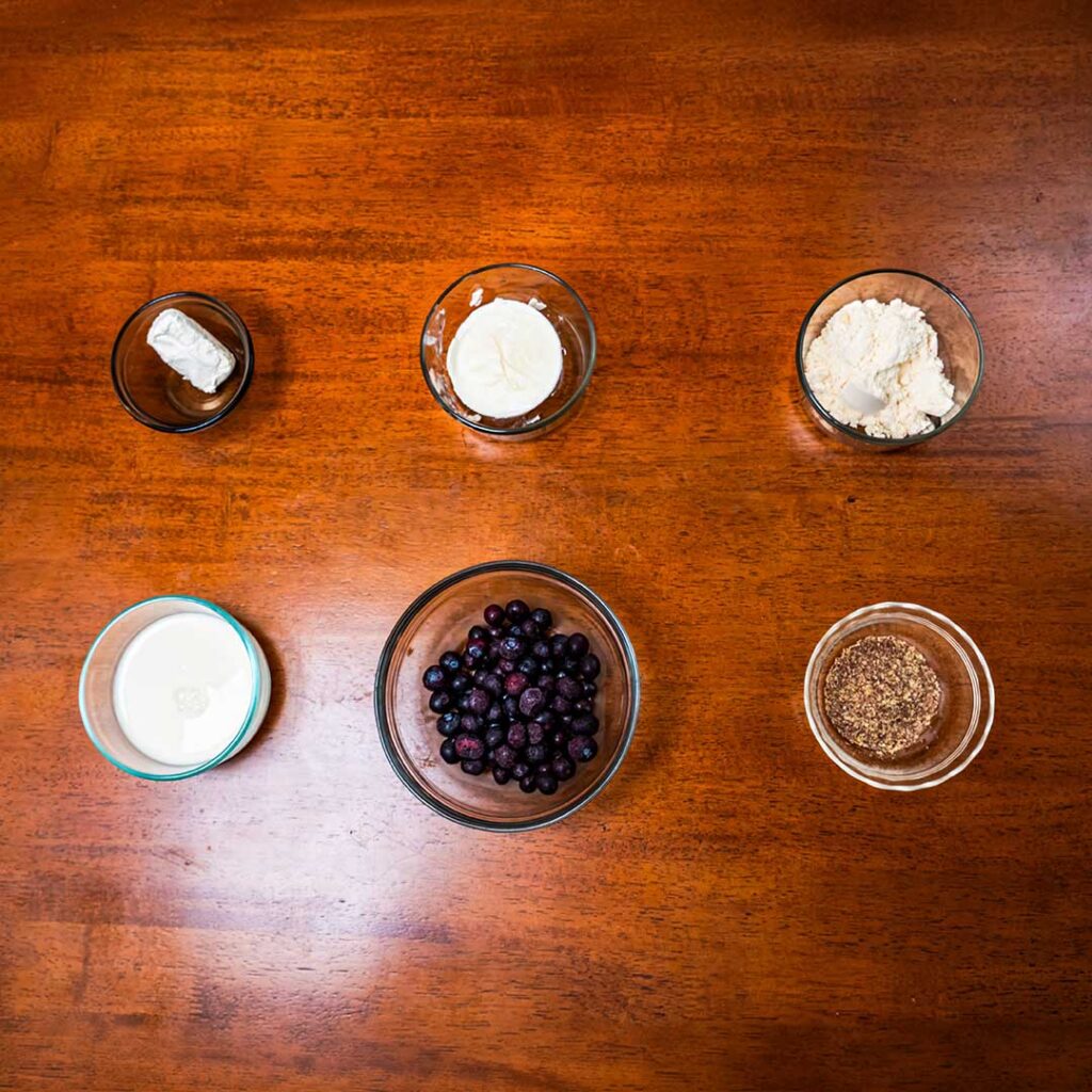 Blueberry cheesecake protein smoothie ingredients &ndash; Greek yogurt, blueberries, protein powder, milk