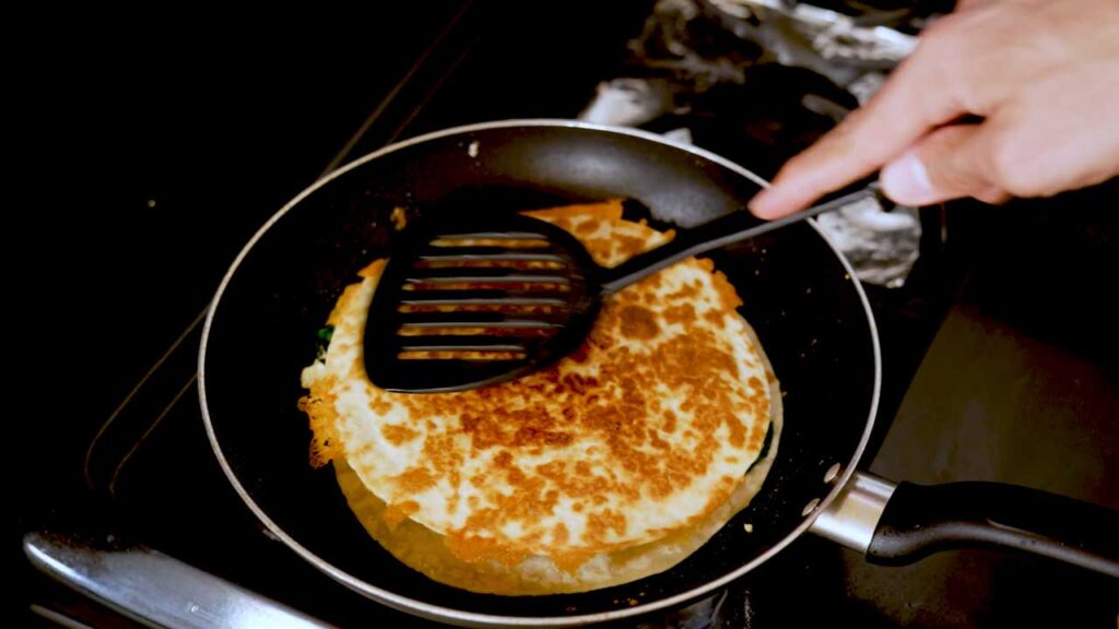 Breakfast quesadilla overhead shot &ndash; high-protein breakfast recipe styled with sour cream, salsa, and avocado on side