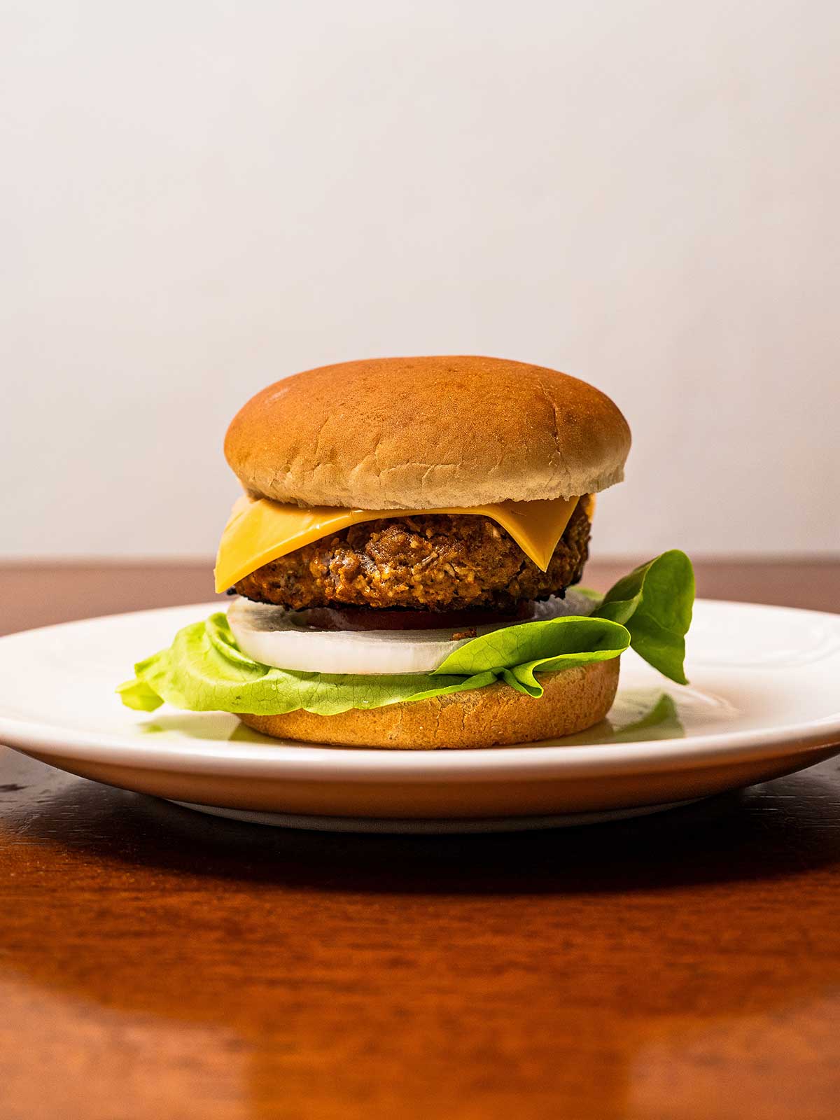 Buffalo burgers on a plate &ndash; spicy high-protein ground turkey burger with melted cheese and toppings