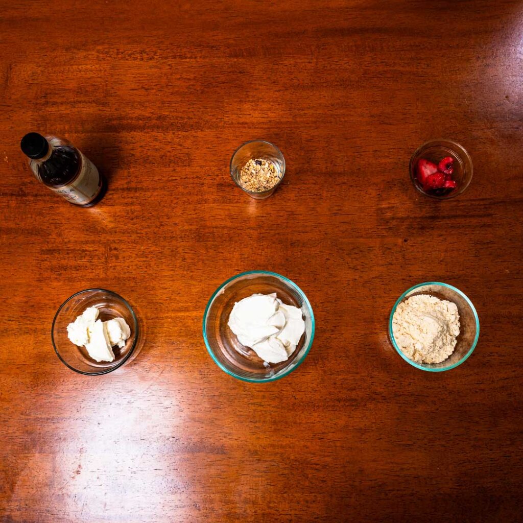 Cheesecake protein yogurt bowl ingredients &ndash; cottage cheese, Greek yogurt, berries for high-protein recipe
