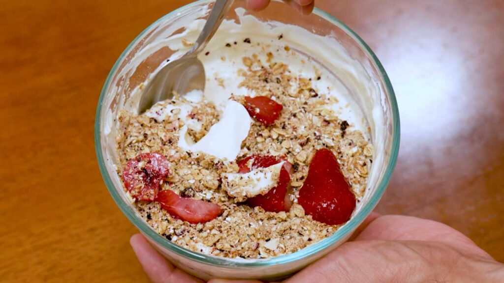 Cheesecake protein yogurt bowl ready to eat &ndash; high-protein breakfast bowl with berries on top
