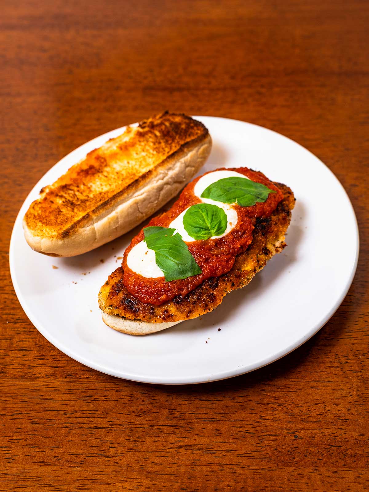 High-protein chicken parmesan sandwich &ndash; breaded chicken with melted mozzarella on ciabatta