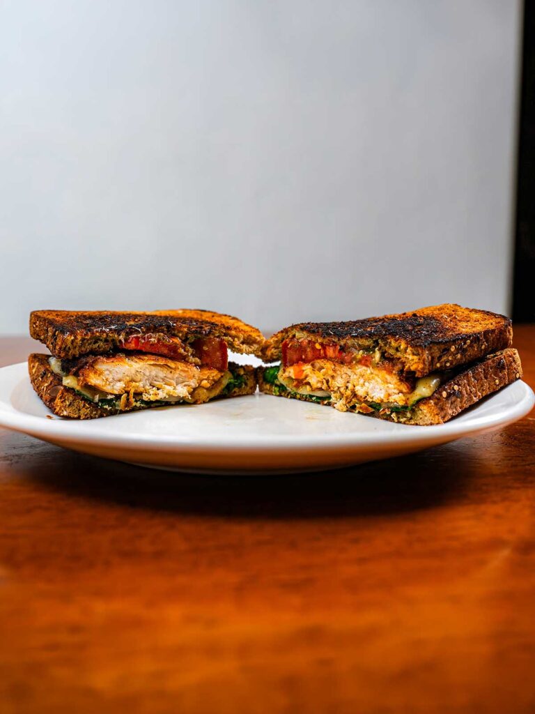 Chicken pesto sandwich on fresh bread &ndash; high-protein lunch with basil pesto