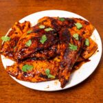 Chipotle honey glazed chicken on a white plate &ndash; high-protein easy dinner recipe