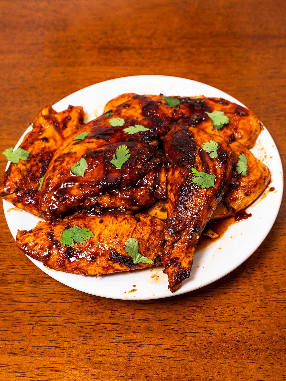 Chipotle honey glazed chicken on a white plate &ndash; high-protein easy dinner recipe