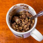 Chocolate chip banana protein mug cake in a microwave-safe mug &ndash; quick high-protein dessert