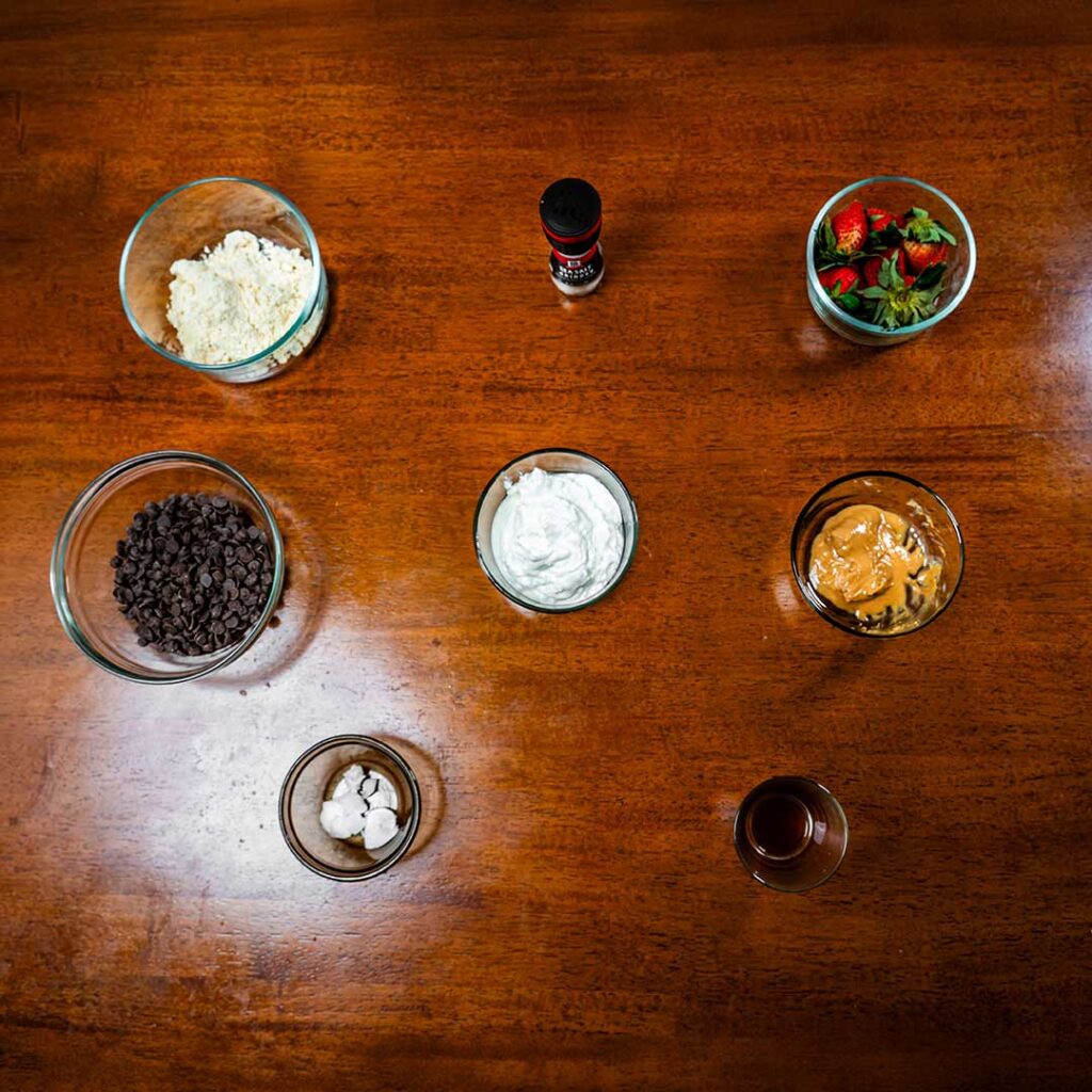 Protein clusters ingredients &ndash; dried strawberries protein powder and chocolate for high-protein snack recipe