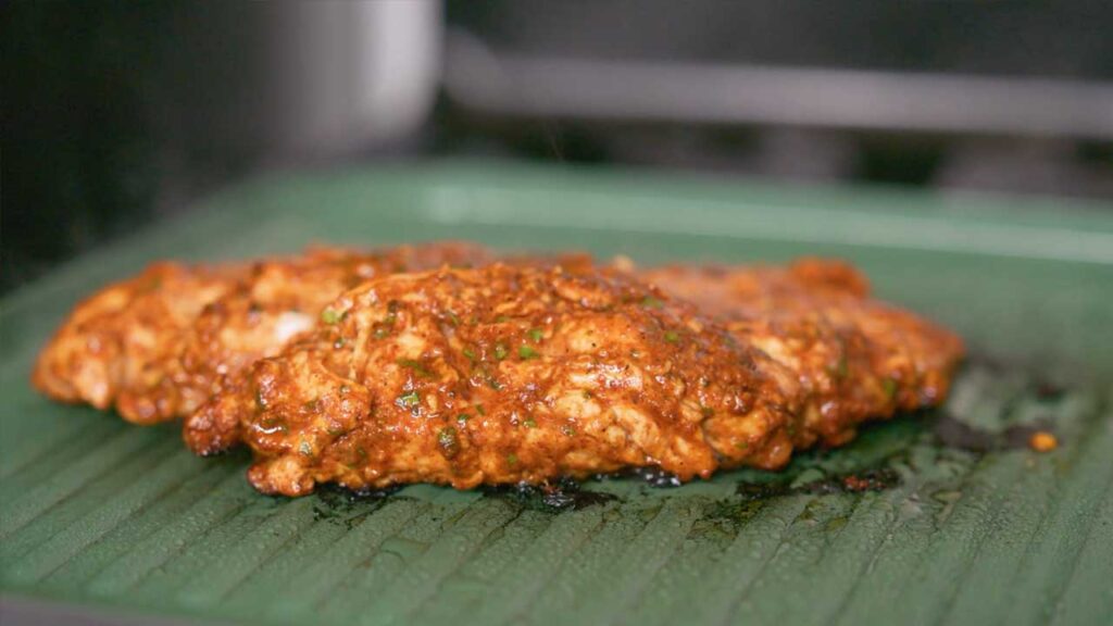 Cilantro lime chicken close-up &ndash; high-protein dinner with fresh cilantro garnish and lime wedges
