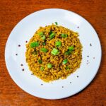 Coconut curry brown rice hero &ndash; creamy high-protein curry with brown rice in bowl on colorful surface
