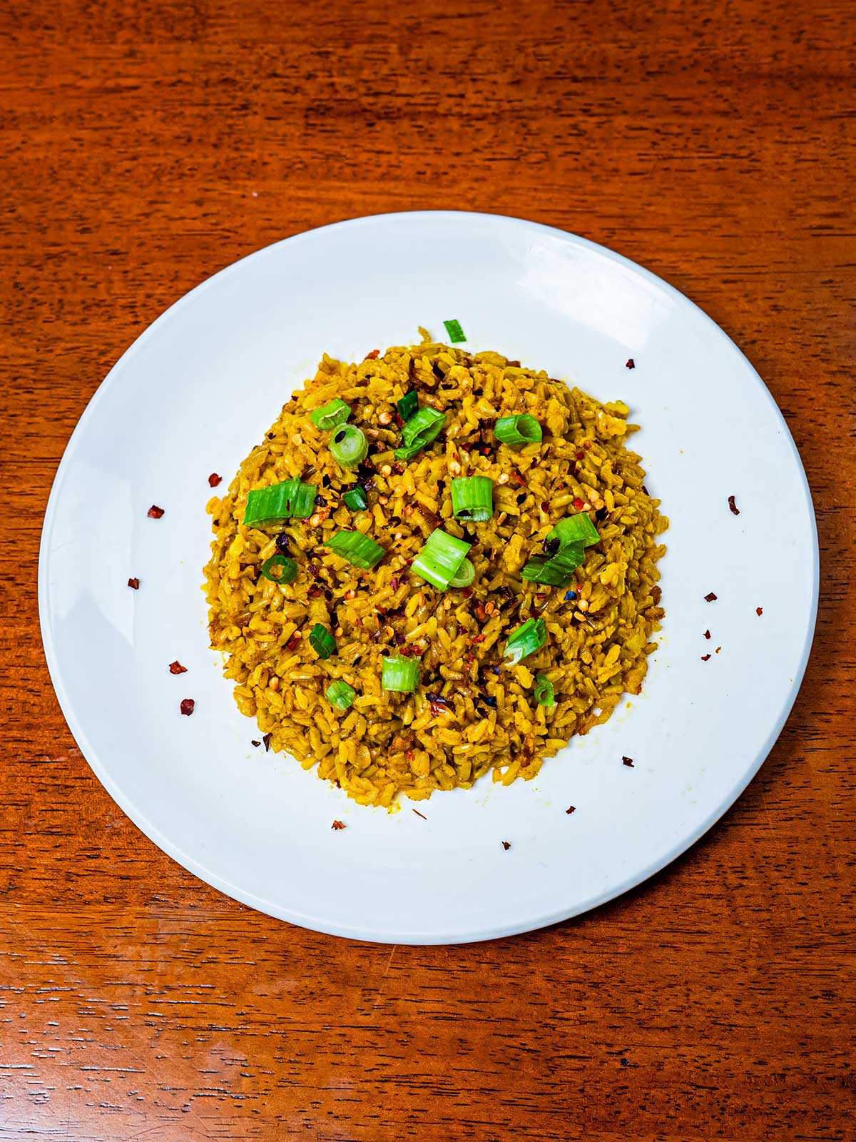 Coconut curry brown rice hero &ndash; creamy high-protein curry with brown rice in bowl on colorful surface