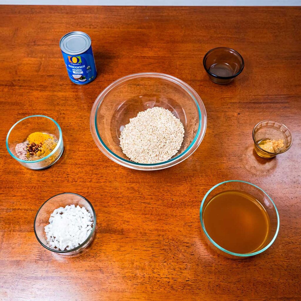 Coconut curry brown rice ingredients &ndash; coconut milk and curry spices for high-protein meal prep recipe