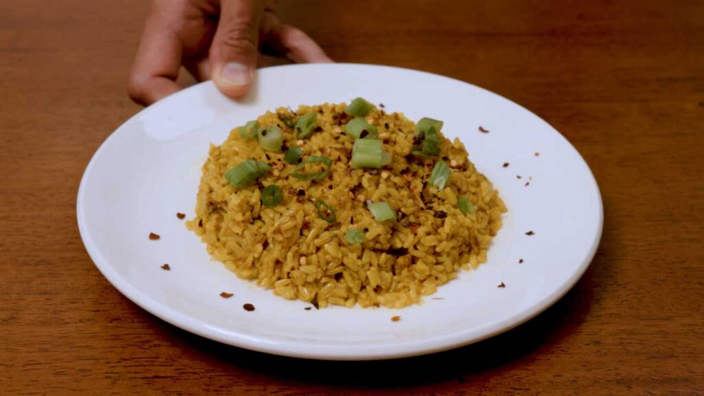 Coconut curry brown rice close up &ndash; creamy high-protein curry bowl with visible spices and herbs garnish
