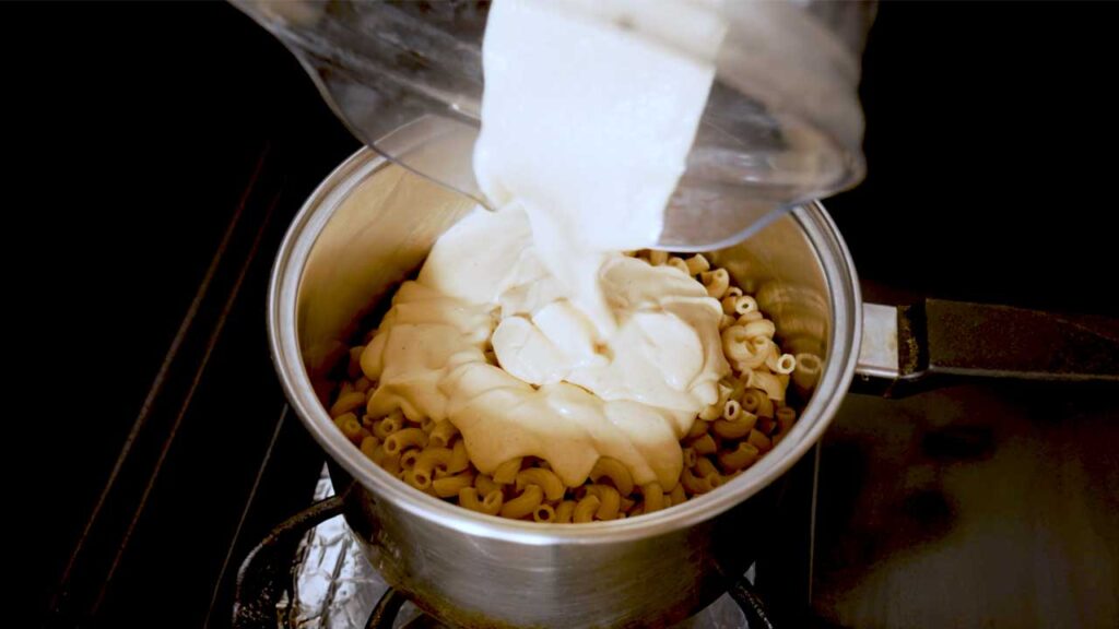 Cottage cheese mac and cheese scoop &ndash; high-protein comfort food showing creamy pasta texture