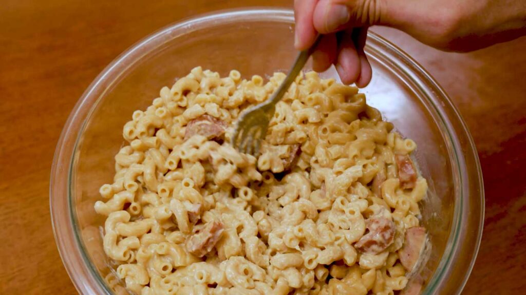 Cottage cheese mac and cheese overhead flat lay &ndash; high-protein comfort food with ingredients around baking dish