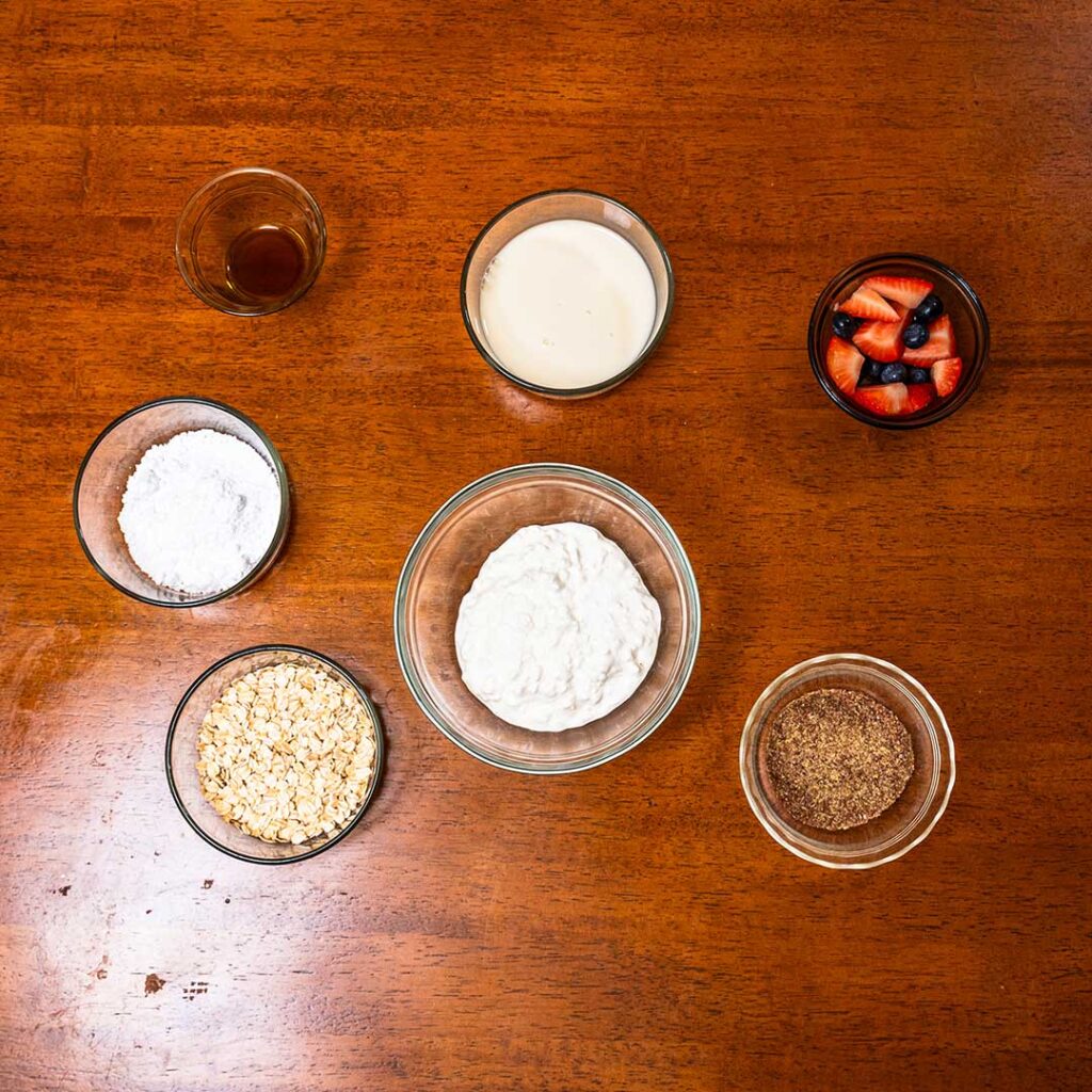 Cottage cheese overnight oats ingredients – rolled oats, cottage cheese, Greek yogurt, honey flat lay