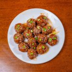 Honey sriracha meatballs on a plate with glossy sauce &ndash; high-protein dinner recipe