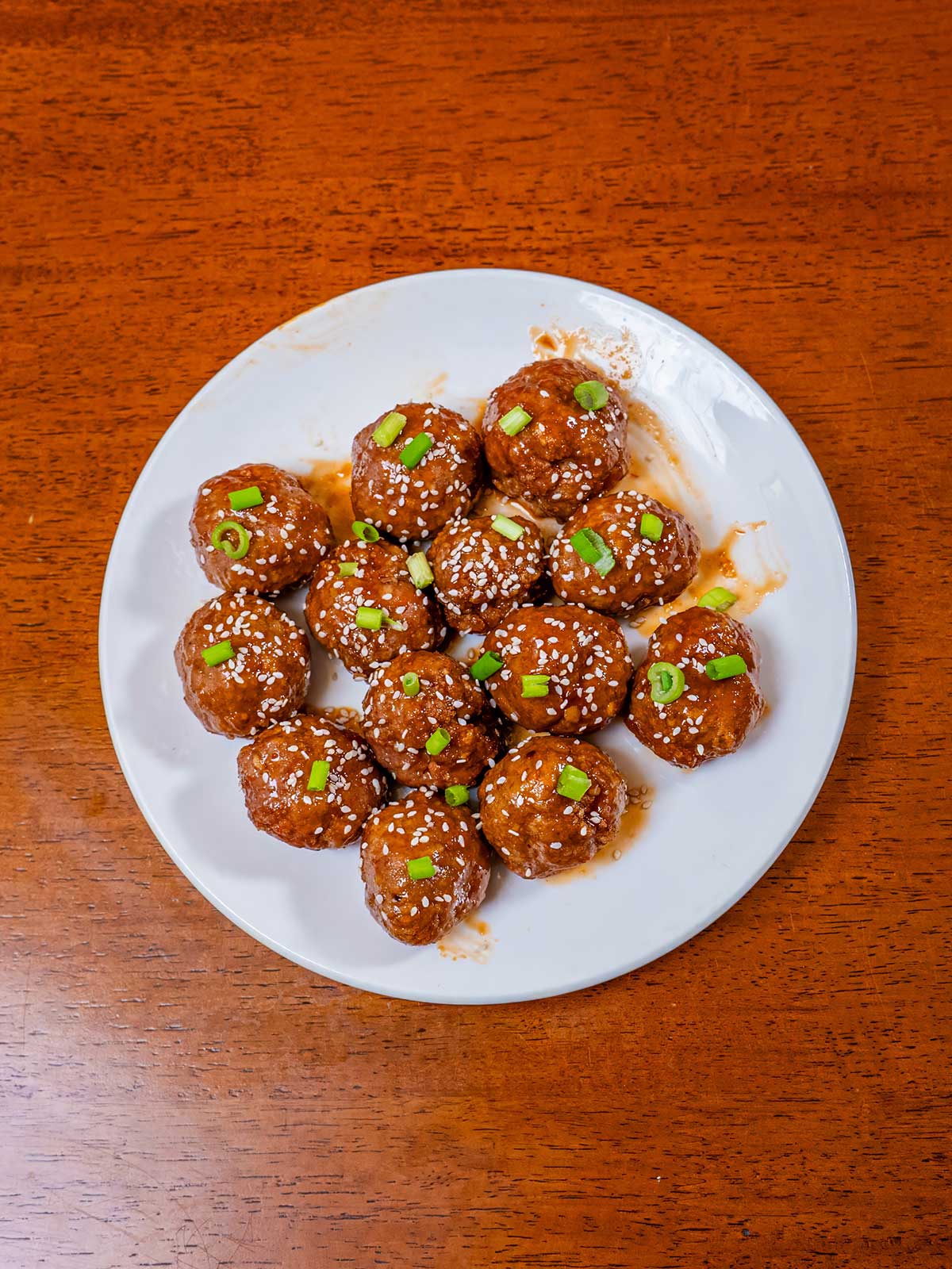 Honey sriracha meatballs on a plate with glossy sauce &ndash; high-protein dinner recipe