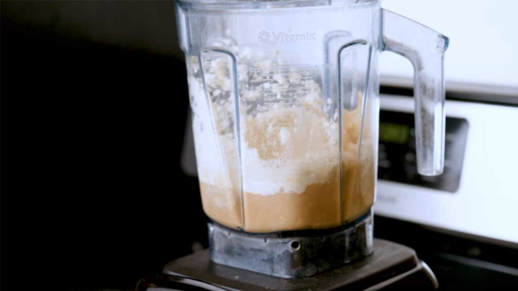 Iced vanilla protein latte close-up &ndash; high-protein creamy coffee with ice in glass