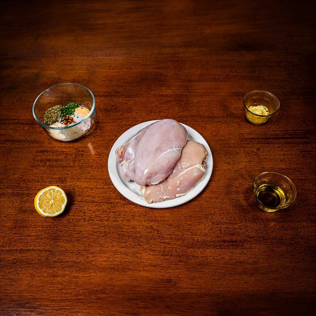 Italian herb chicken ingredients &ndash; chicken breast, garlic, rosemary, thyme, olive oil