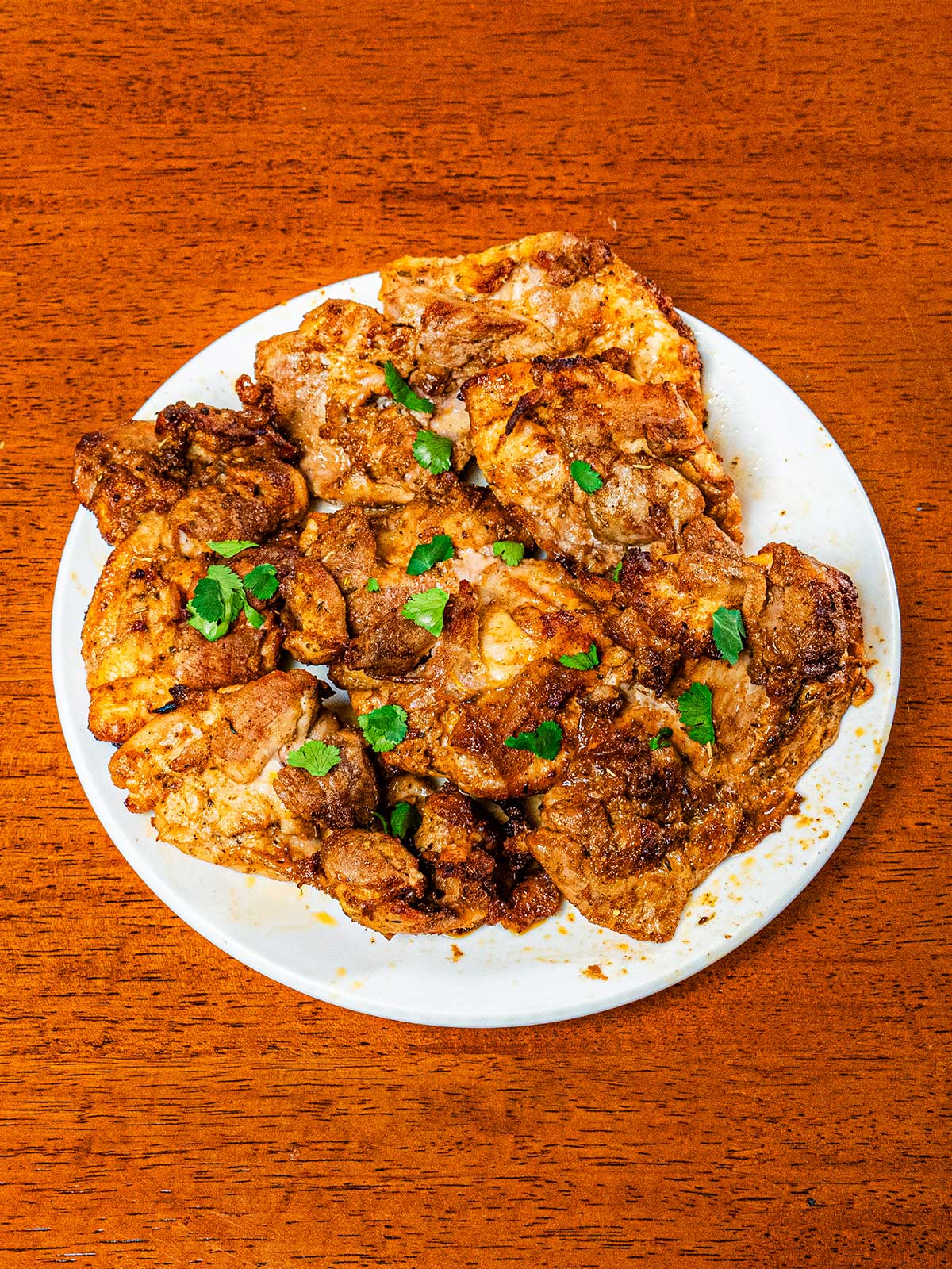 Lemon pepper chicken breast on plate &ndash; high-protein dinner with lemon and herbs garnish