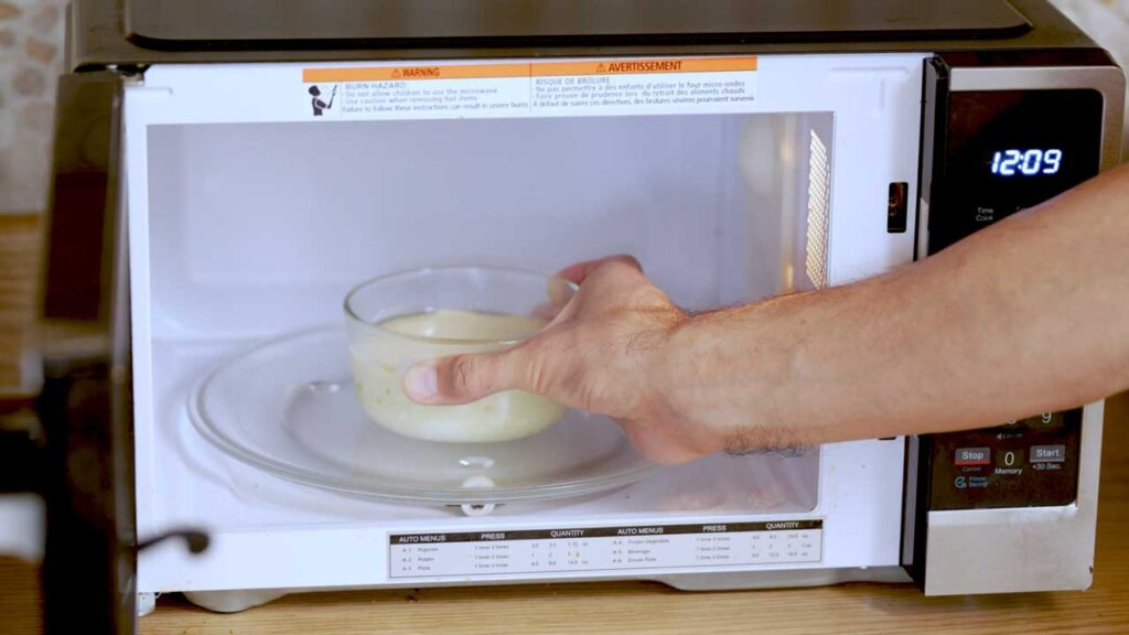 Microwave cheesecake with spoon bite – high-protein dessert showing fluffy interior in ramekin