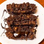 Protein chocolate banana bread recipe &ndash; sliced high-protein loaf with rich chocolate swirl on wooden board