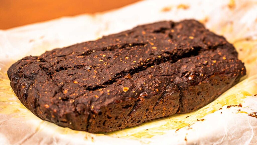 Protein chocolate banana bread on wire rack &ndash; fresh baked high-protein breakfast loaf