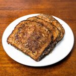 Protein coffee french toast on a plate &ndash; high-protein breakfast with cinnamon sugar and whipped topping