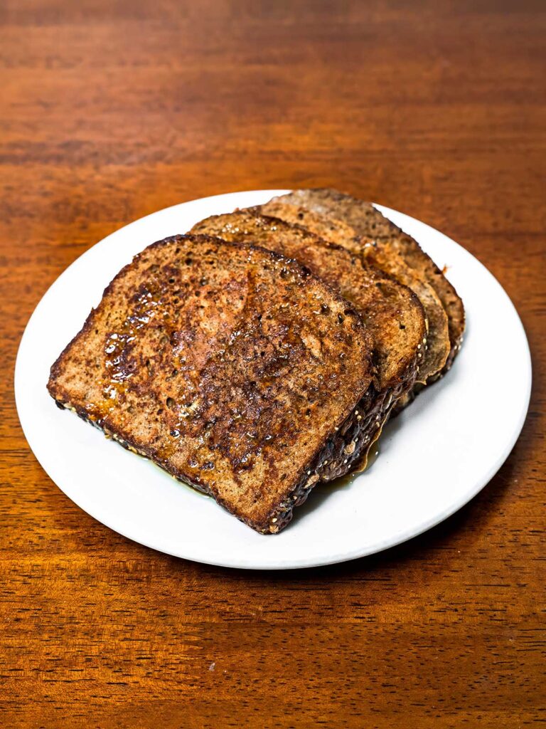 Protein coffee french toast on a plate &ndash; high-protein breakfast with cinnamon sugar and whipped topping