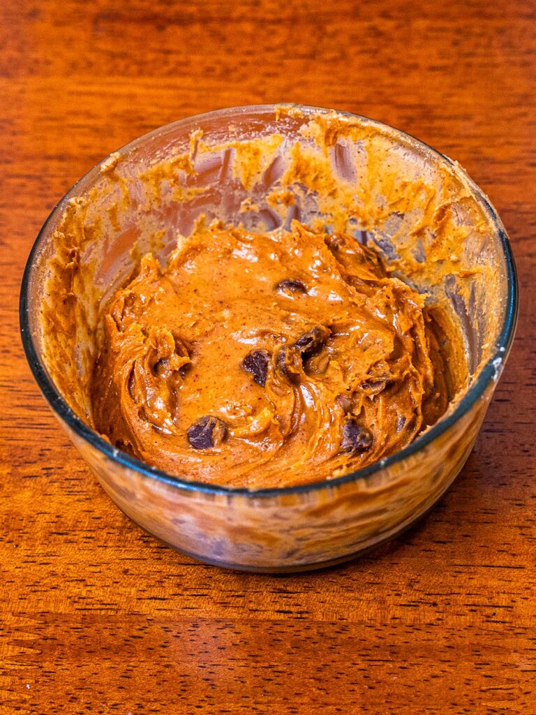 Protein peanut butter cookie dough hero shot &ndash; high-protein healthy dessert with chocolate chips and peanut butter