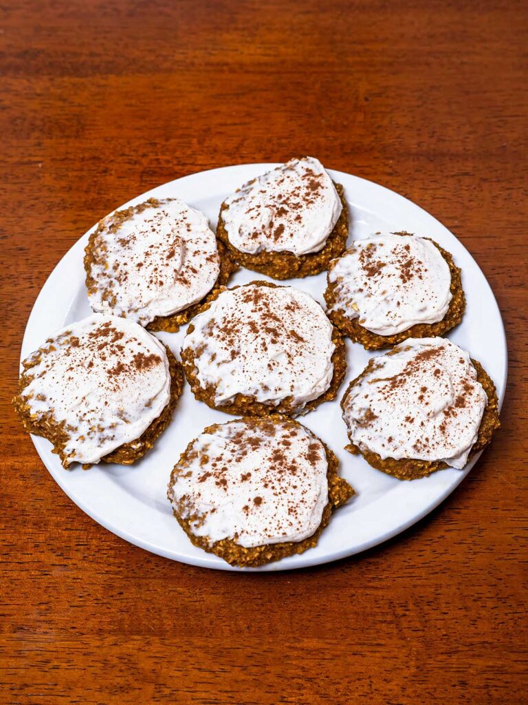 Pumpkin oatmeal cookies hero &ndash; stack of soft high-protein healthy cookies on rustic surface