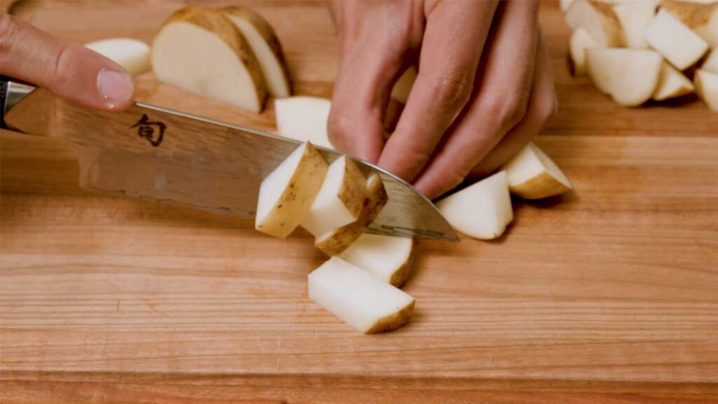 Roasted garlic parmesan potatoes close-up &ndash; crispy golden potatoes with melted parmesan