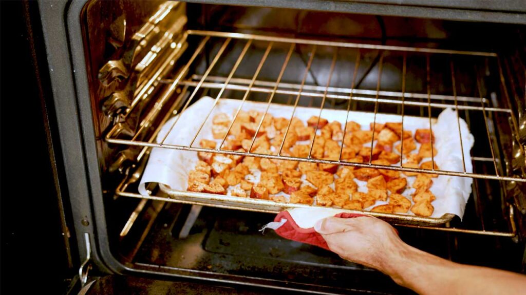 Roasted sweet potatoes plated &ndash; high-protein healthy side dish with herb garnish and seasoning