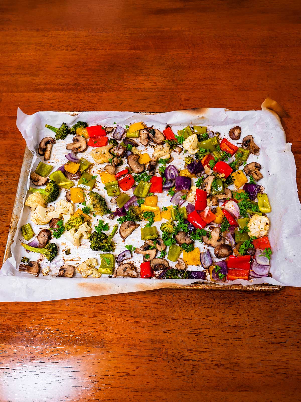Roasted vegetables medley &ndash; bell peppers broccoli cauliflower and mushrooms on baking sheet