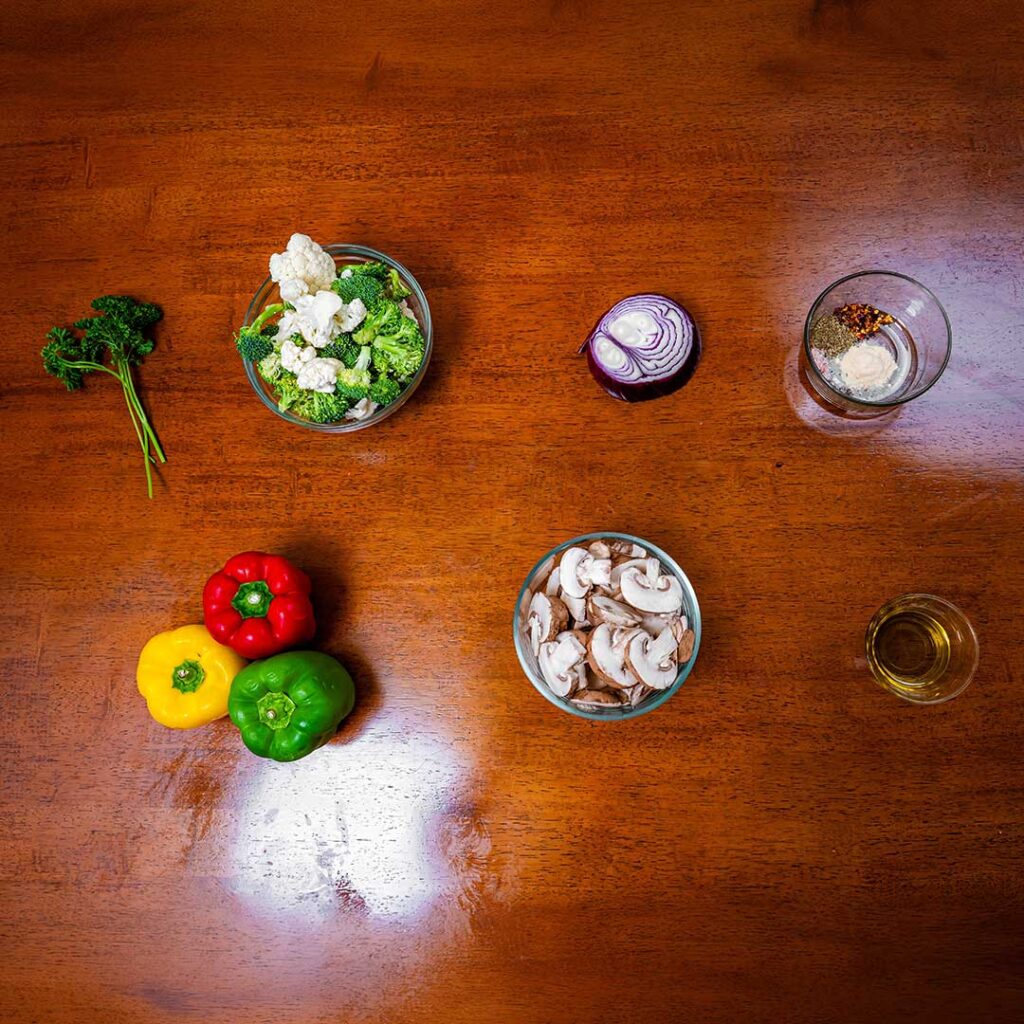 Roasted vegetables ingredients &ndash; bell peppers broccoli cauliflower and mushrooms for a healthy recipe