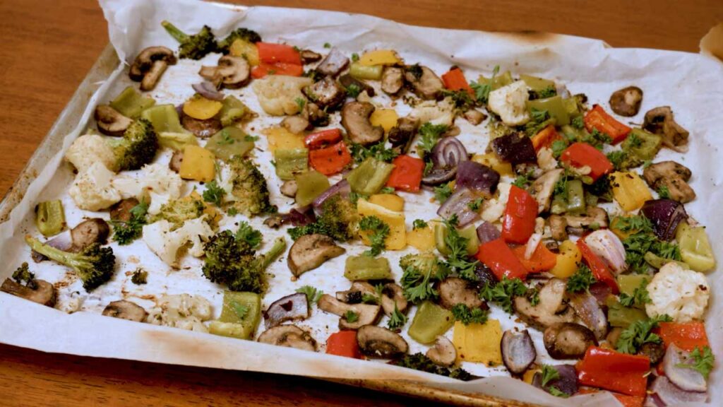 Roasted vegetables step-by-step &ndash; tossing raw vegetables with oil and seasoning before roasting