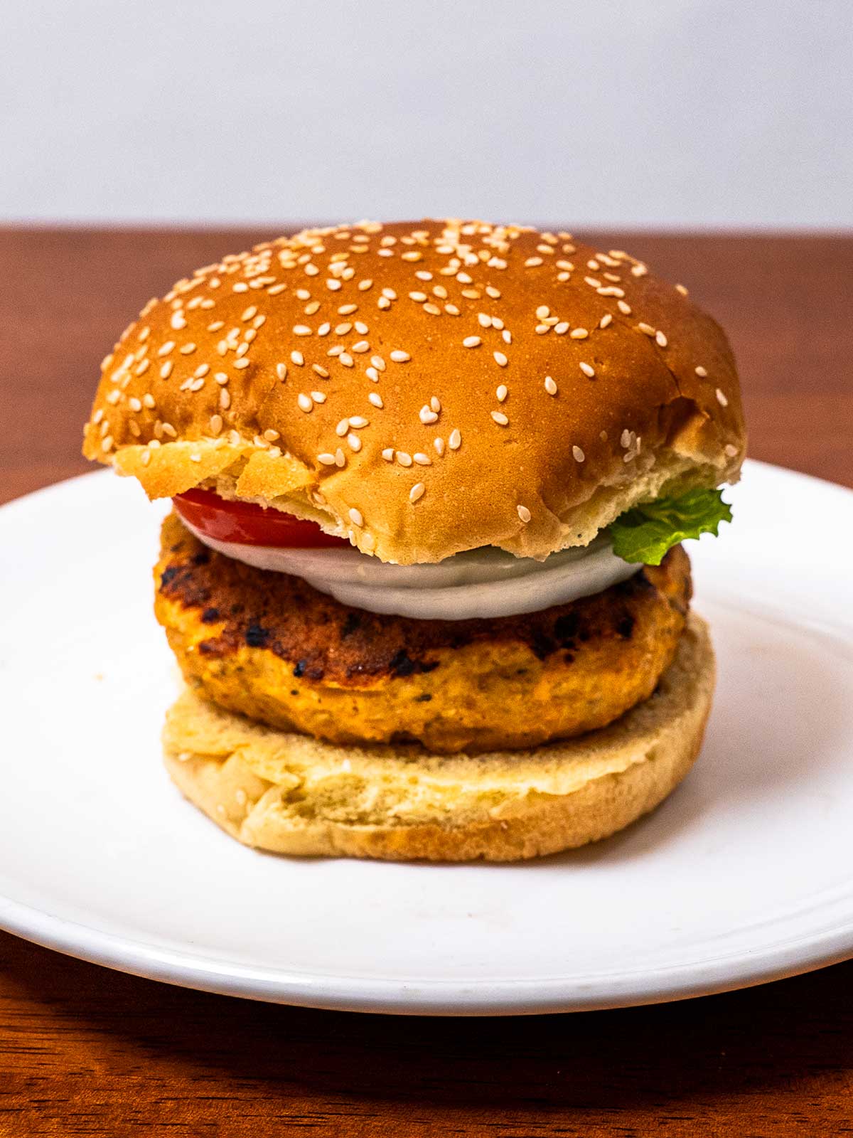 Salmon patties recipe &ndash; golden-brown high-protein salmon cakes on a white plate with lemon
