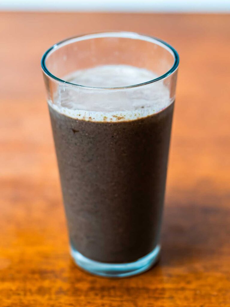 Spinach acai smoothie &ndash; vibrant purple high-protein breakfast smoothie in a glass