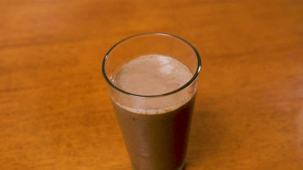 Garnished spinach acai smoothie &ndash; high-protein breakfast with banana slices and chia seeds