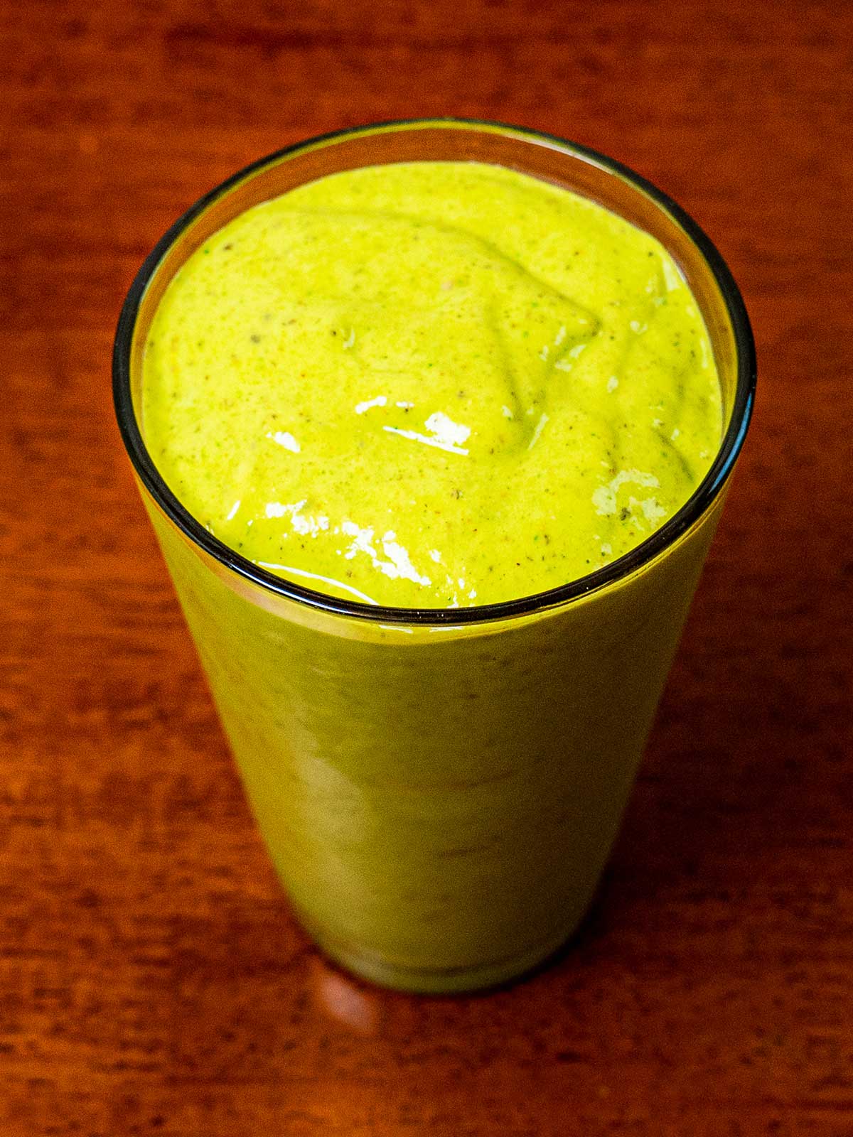 Tropical green protein smoothie in a glass with banana and mint &ndash; high-protein breakfast recipe