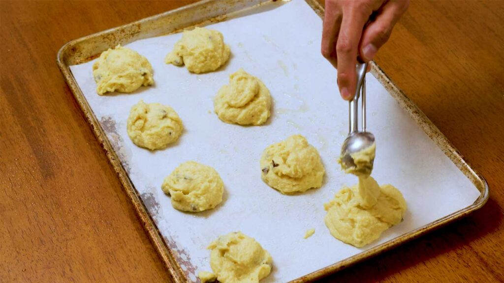 Vanilla coconut protein cookies mixing bowl &ndash; combining protein powder and shredded coconut for high-protein dessert dough
